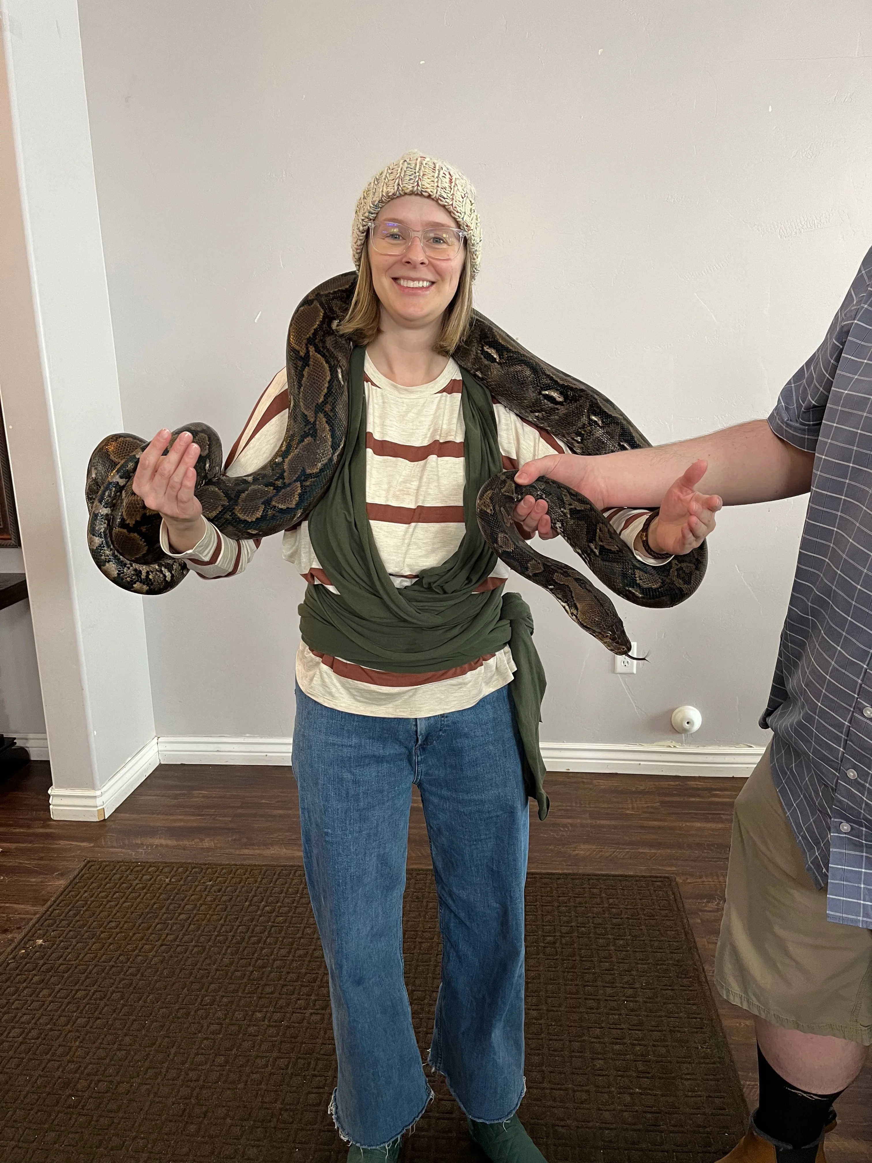 Kerianne smiling with a large python draped across her shoulders